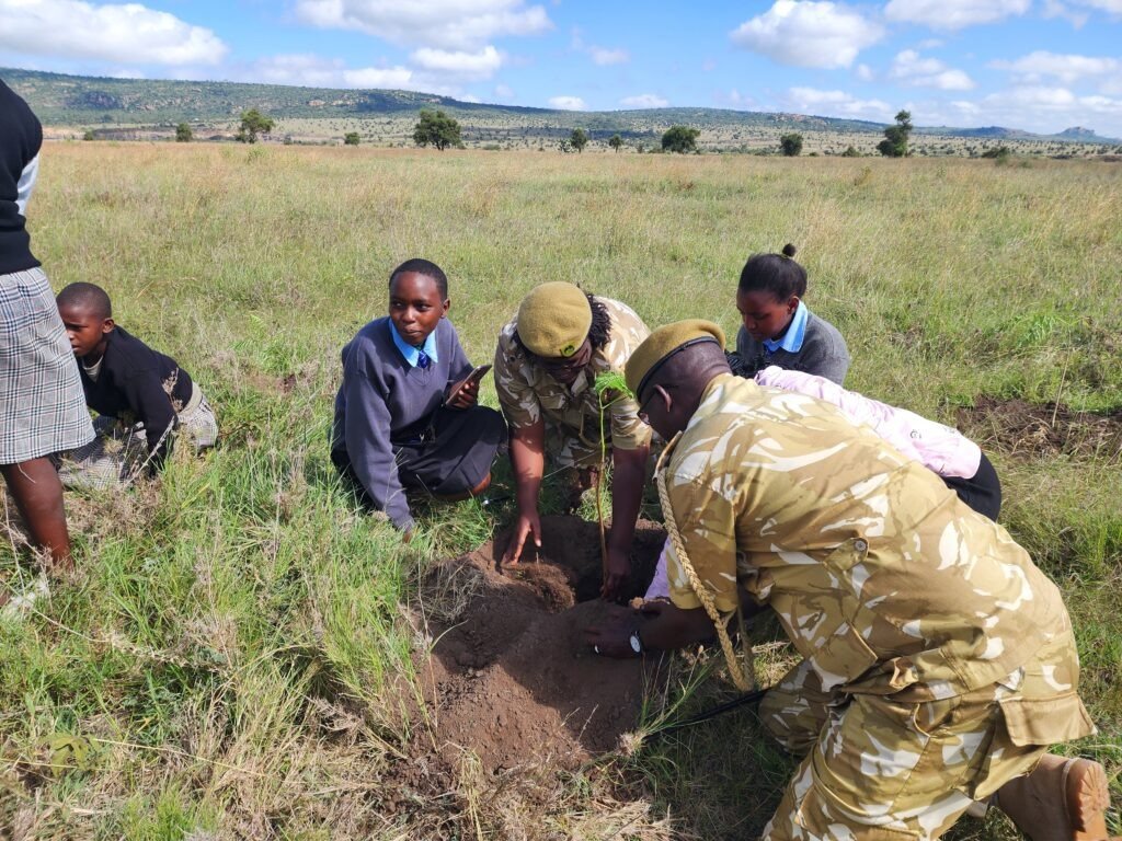 officers encouraging students to plant